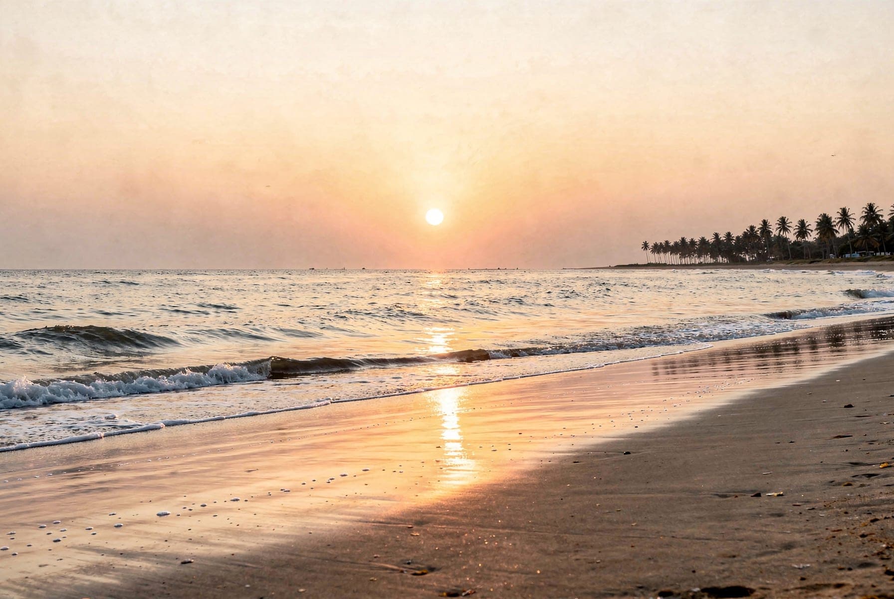 The shoreline at first light, the sun just clear of a flat sea and the wet sand mirroring a pale gold sky.