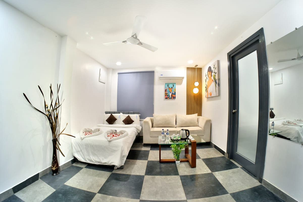 The second bed in a Suite Cottage, made up beside the three-seater sofa in the living area.